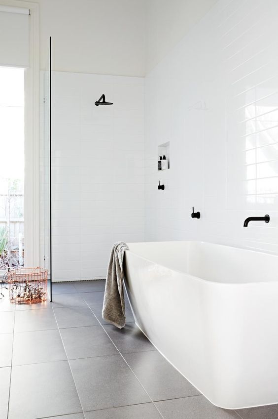 Inside Out is one of my favorite Australian sources for residential architecture, and with this open shower and tub there's little to guess why. This walk-in shower adjacent to the tub is fantastically minimal and the black hardware just pops against the white subway tile wall.