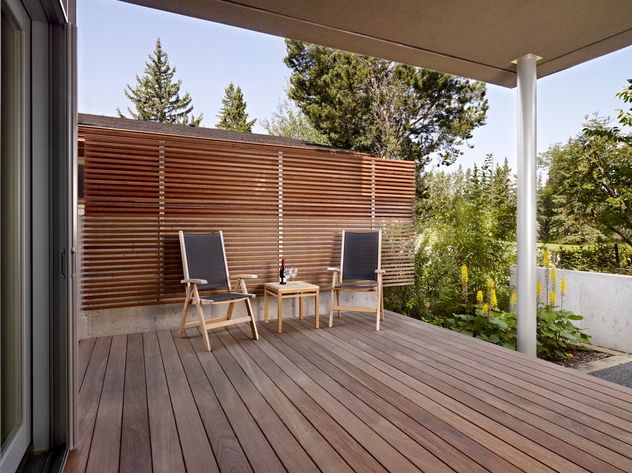 This modern horizontal fence, mounted to a concrete wall, is more than my backyard can manage, but the design is gorgeous. This design continues the wide spacing trend of the first image, but in a more modern way.#ThisOldHouse fence inspiration via www.L-2-Design.com