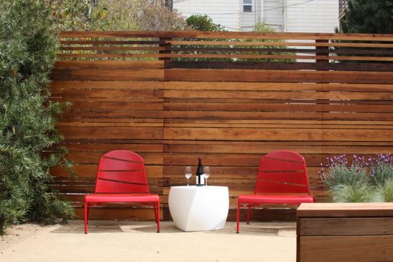 This modern horizontal fence carries through both varying plan spacing at the base and body of the fence, as well as a wide-spaced header/cap detail. The wood even looks reclaimed - two thumbs up. #ThisOldHouse fence inspiration via www.L-2-Design.com
