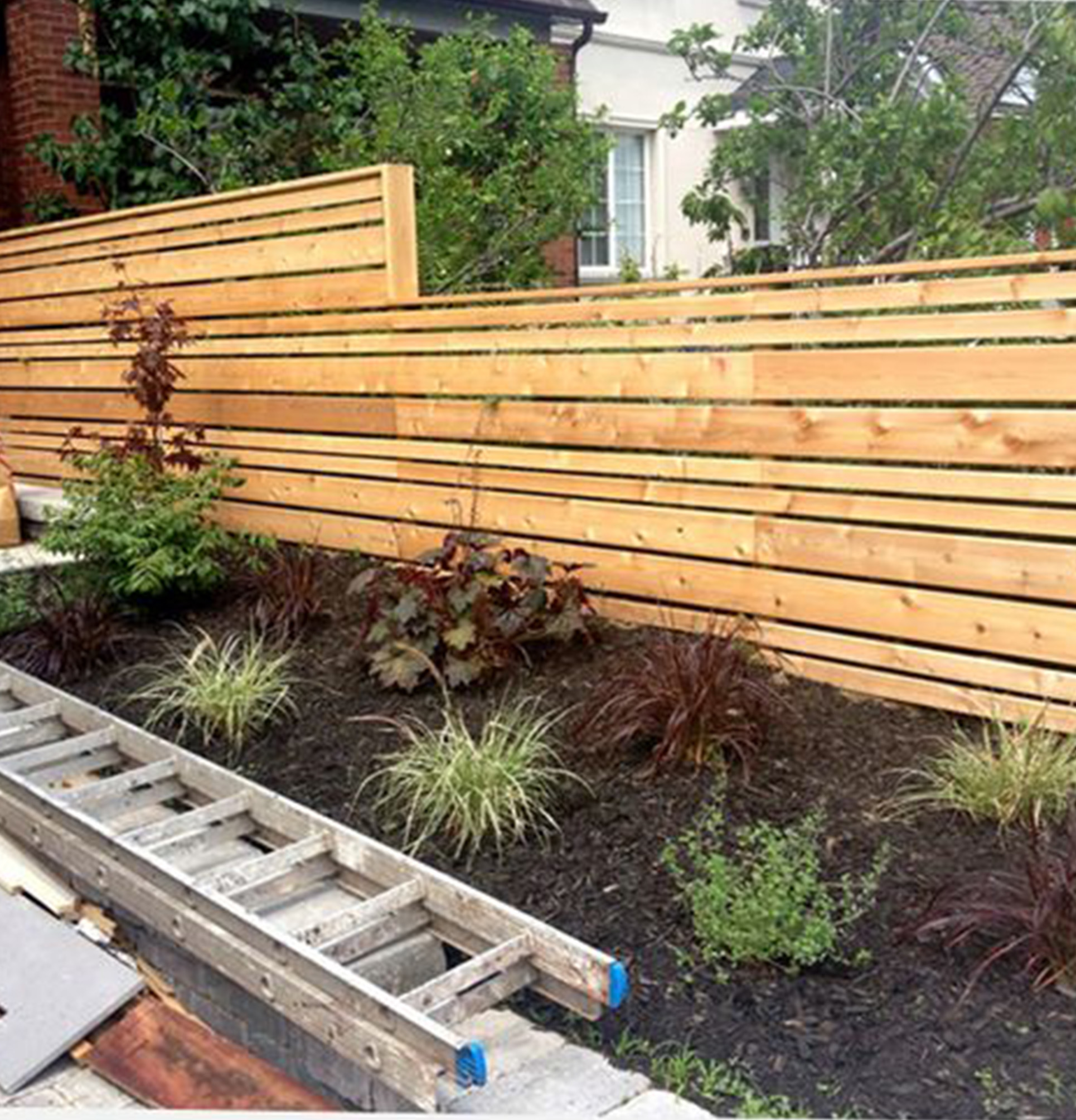 The staggered widths in this modern horizontal fence break up the height in a nice way. I also like the cap detail that cleans up the overall height drop. I'll be having to drop the height of my fence because of grade changes along the backyard, so this is definitely something that will come into play. #backyard #fence inspiration via www.L-2-Design.com