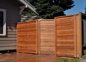 This double gate that continues the lines of a modern horizontal fence is framed with smaller end caps that don't deter from the horizontal lines too significantly. I'll likely cover gates next week, so stay tuned! #backyard #fence inspiration via www.L-2-Design.com