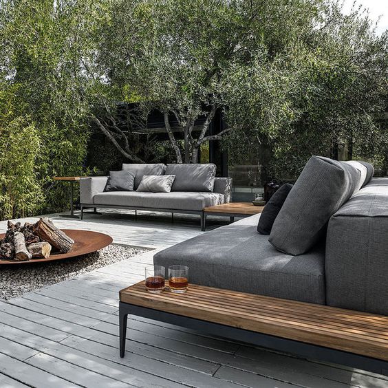 This first patio paver system has almost everything I love and ended up going with in it. Modern sectionals. Modern concrete pavers. Wood side tables. Metal fire pit. Rock accent. Love it all. #backyard inspiration via www.L-2-Design.com