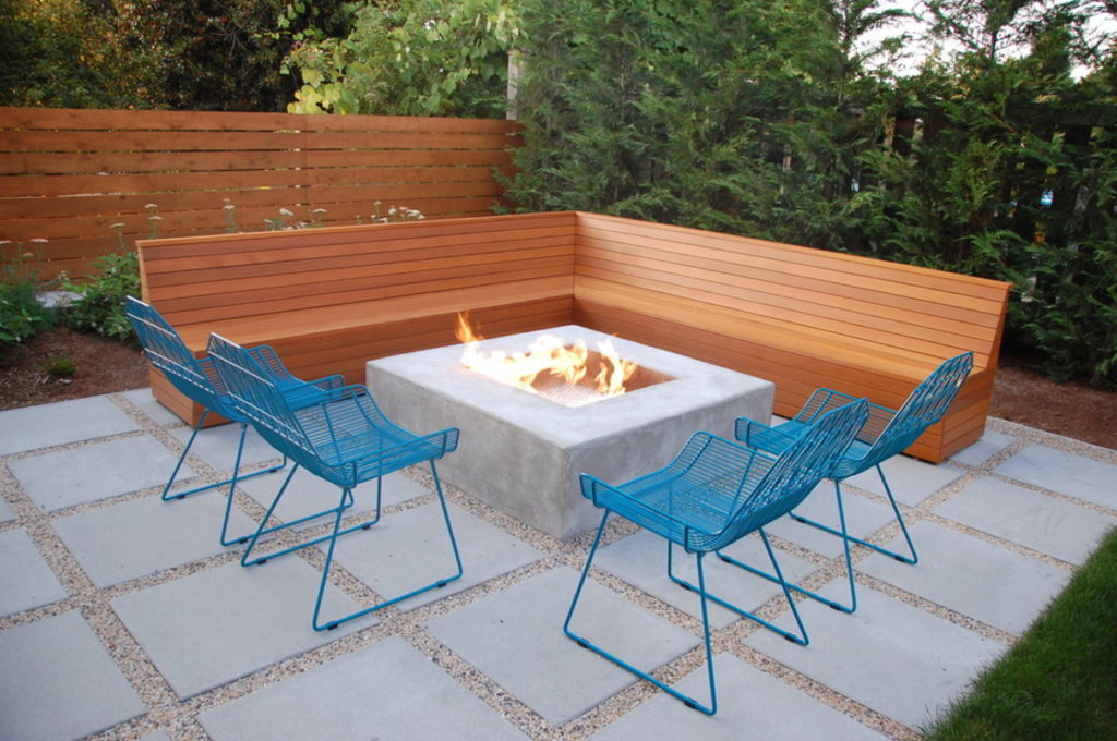 A great patio paver system with rock edging AND a built-in wood seating element. The cast-in-place firepit is gorgeous, too - with the added benefit of retaining heat without burning a user like metal will.