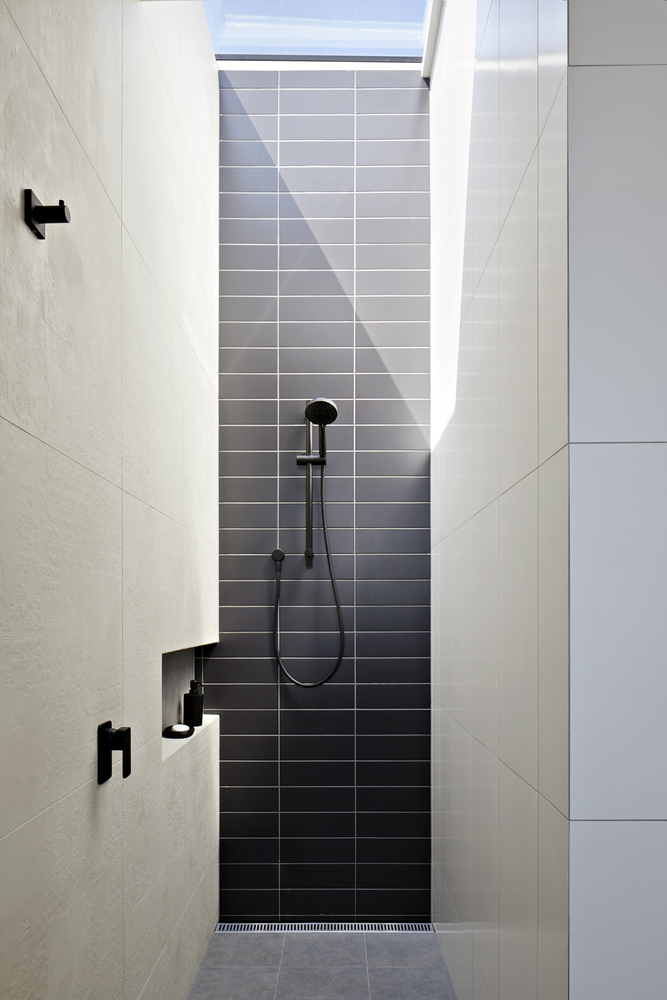 What I wouldn't give for a skylight in the bathroom to offset a great design with black shower hardware. via www.L-2-Design.com