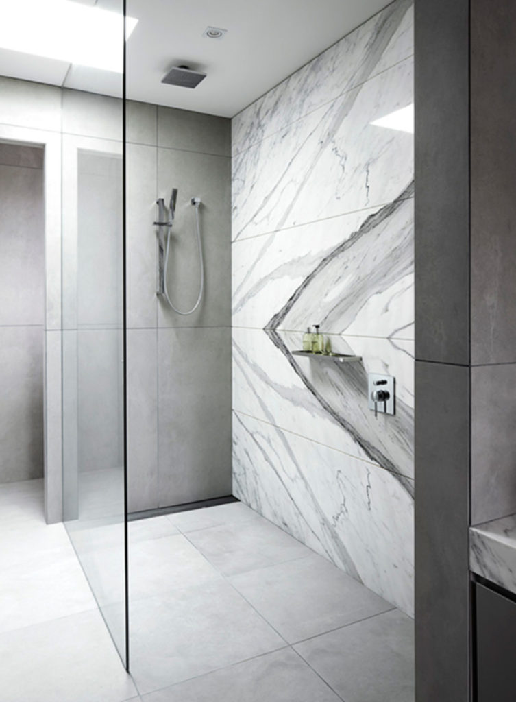 Rhys Jones and this marble bathroom tile accent wall are a match made in heaven. That slab work is beyond beautiful. Add a wing wall and a trench drain and you're speaking my design language. #bathroom inspiration via www.L-2-Design.com
