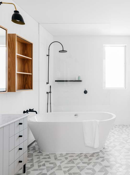 Arent & Pyke designed a stunningly bright bathroom with simple black shower hardware that stands out against the white tile walls. via www.L-2-Design.com