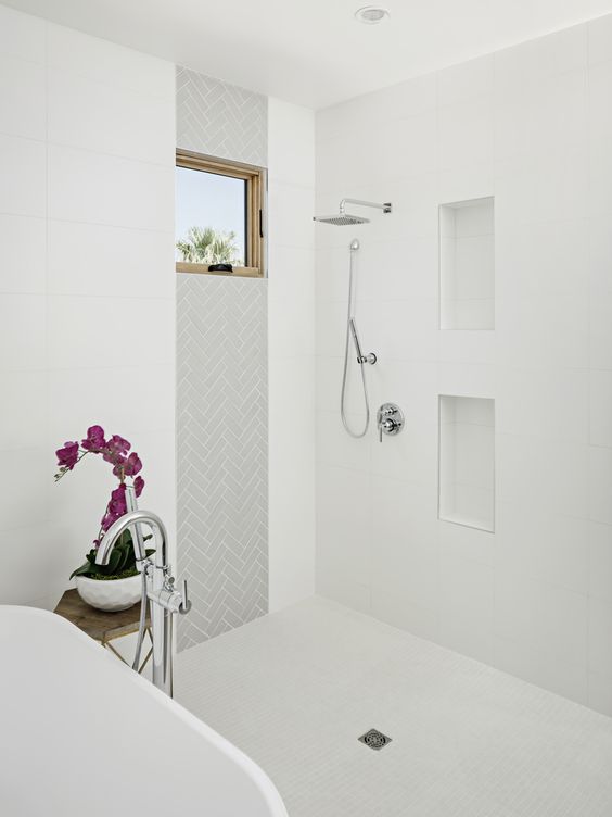 Here's a more contemporary charmer by The Ranch Mine. My shower and tub won't be this close, but I love how the shower tile envelopes the room as a larger wet space. The alignment of the herringbone (again) tile and window frame is a pretty solid design move, too. Bathroom shower tile inspiration via www.L-2-Design.com