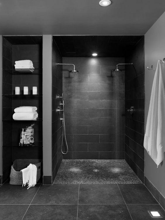 Hello, noir! While I think I'd prefer the lightness of white open spaces for my morning shower, this moody black double shower uses large format shower tile to make the color the focus. I'm surprised they didn't use a charcoal grout, but to each their own. Bathroom shower tile inspiration via www.L-2-Design.com