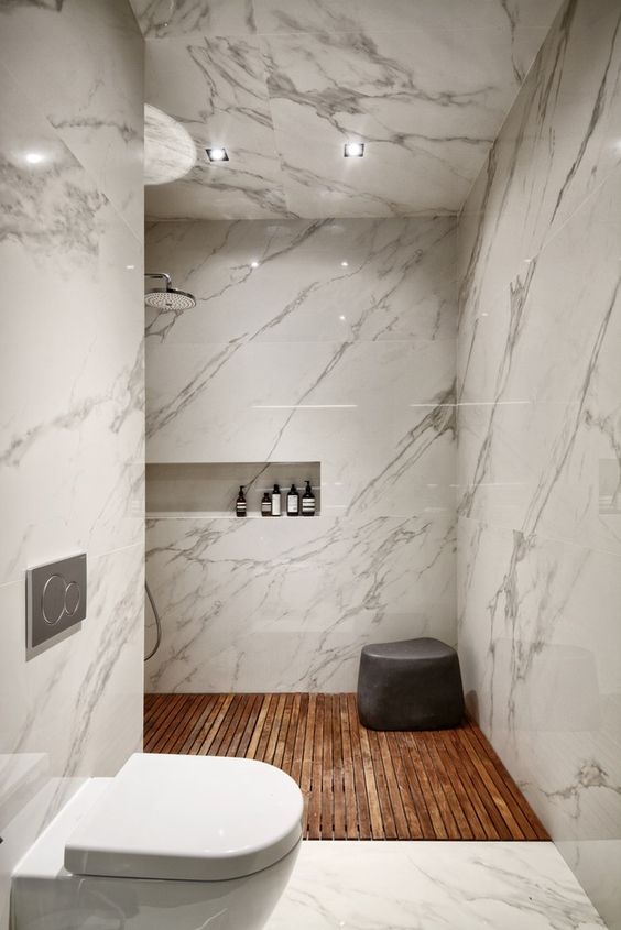 This marble shower tile says GLAM, and I kinda like it. I think it's too glossy and glam for me, and drives me a bit batty that it's on the ceiling, but to each their own. I spy more cool alcoves with Aesop bathing goodies, too. Bathroom shower tile inspiration via www.L-2-Design.com
