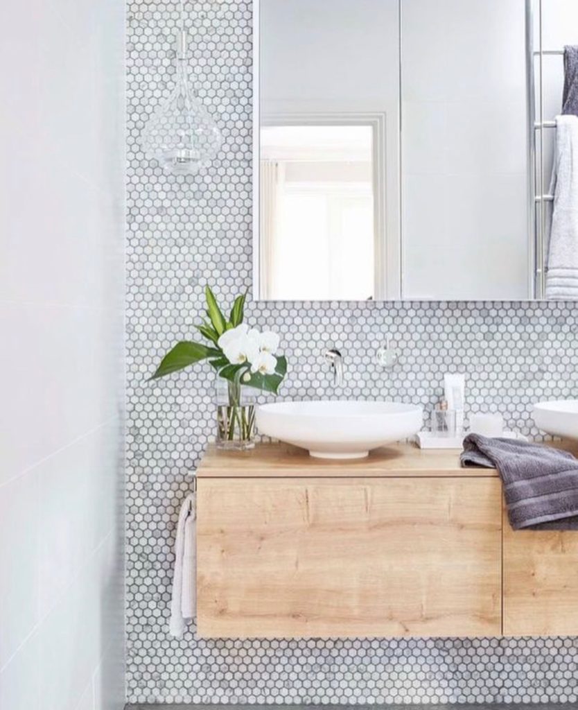 Another hexagonal mosaic tile backsplash to complement this modern sink. This design's use of material and color creates a tranquil, spa feel that I can only imagine makes for a wonderful oasis after a stressful work day.