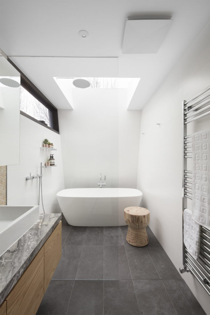 Similar to the Dark Horse, the Jigsaw House by McMahon and Nerlich sits sustainably on a narrow lot by stacking its form vertically.  The simple shapes allow light to filter in softly, and the rainhead shower is situated within the opening of the bathroom skylight, which I'm sure makes it seem like you really are rinsing off with rain.