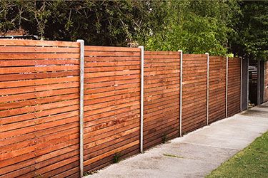 This fence design steps with the grade, but is interrupted by the vertical posts...and doesn't continue the horizontal alignment. While this picture reinforced my desire for horizontal fencing, I can't say there aren't things I would do differently! #Backyard inspiration via www.L-2-Design.com