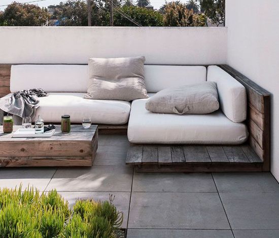 Taking a more refined pallet approach, these low-sitting wood sectionals create a bohemian patio design that looks oh-so-wonderful for Sunday naps. Backyard inspiration via www.L-2-Design.com