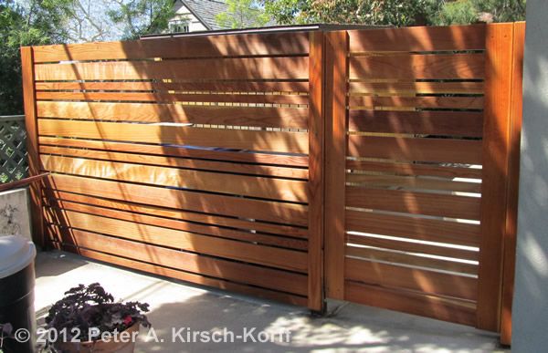While it looks like this fence provides only pedestrian access, it would be relatively easy to adapt and create a hinged opening for vehicles with the larger section to the left in the picture. #backyard inspiration via www.L-2-Design.com