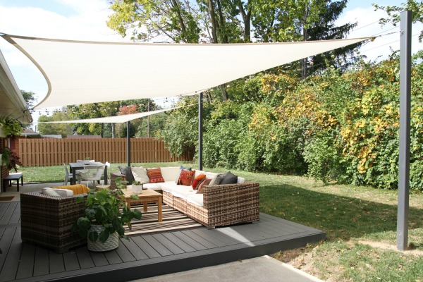 A patio renovation added a modern shade sail to this backyard. #backyard inspiration via www.L-2-Design.com