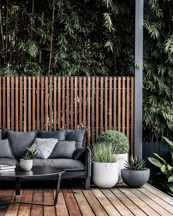 This modern vertical fence is well-built and detailed, with a minimal top cap and bar connecting each of the vertical strips. #backyard inspiration via www.L-2-Design.com