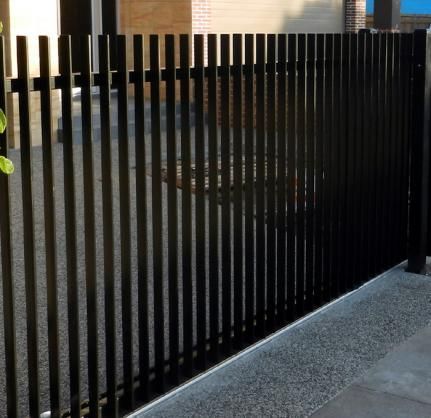The spacing of the vertical slats on this modern vertical fence allows for light and vision without compromising security. #backyard inspiration via www.L-2-Design.com