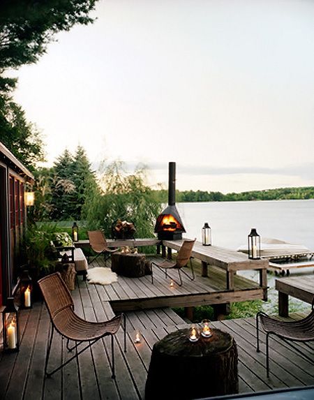 Candles, boats, fire, benches and comfy seats - what's not to love about this lake cabin? #backyard inspiration via www.L-2-Design.com