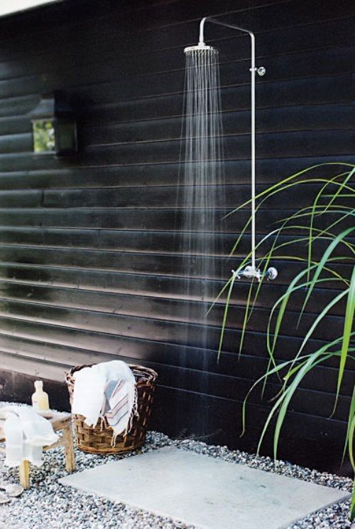 Simple and elegant, this modern outdoor shower has a stool for your gear, a basket for your towel, and a concrete pad for your feet. #backyard inspiration via www.L-2-Design.com