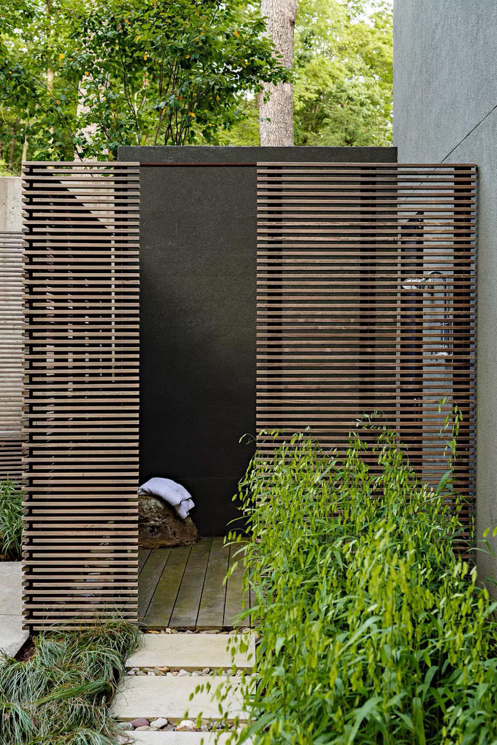 An ultra-modern outdoor shower enclosure merges wood and concrete to create a private space to get clean on a warm day. #backyard inspiration via www.L-2-Design.com