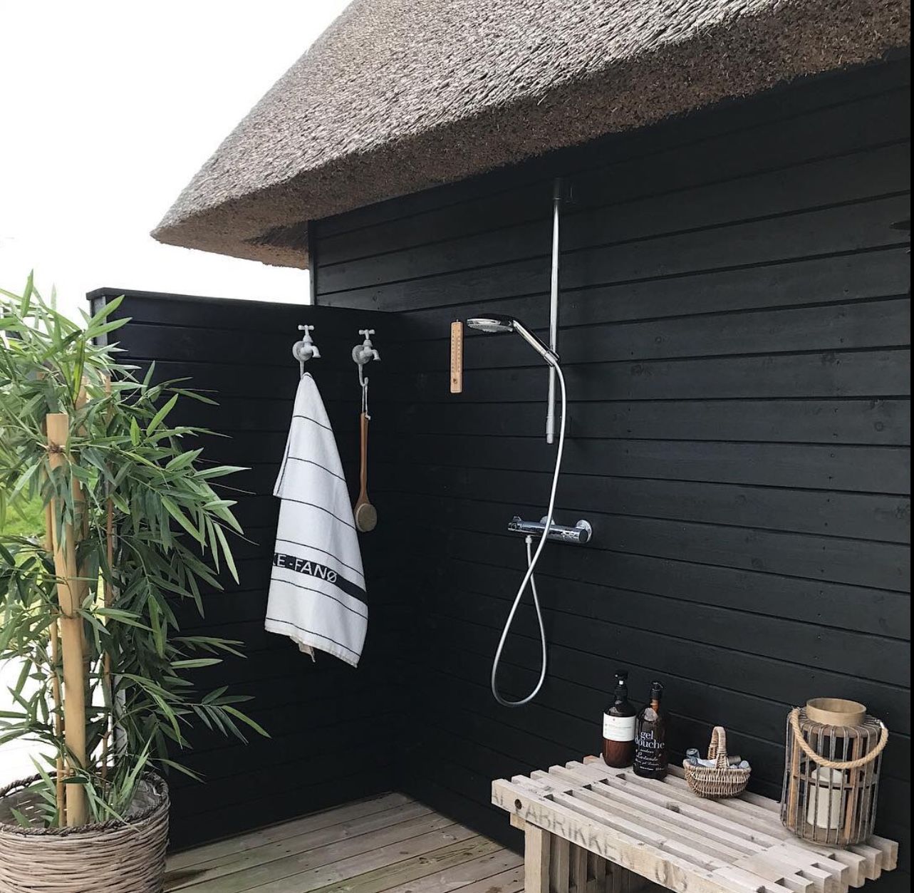The thatched roof hints at a nearby beach, but this modern outdoor shower design stays simple and true to the function of the space. #backyard inspiration via www.L-2-Design.com