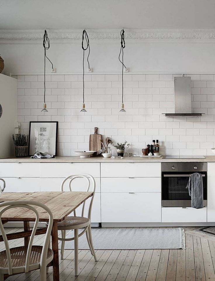 A beautiful, simple nordic home shows how easily a kitchen cooktop can blend in with the larger counter. #kitcheninspiration via www.L-2-Design.com