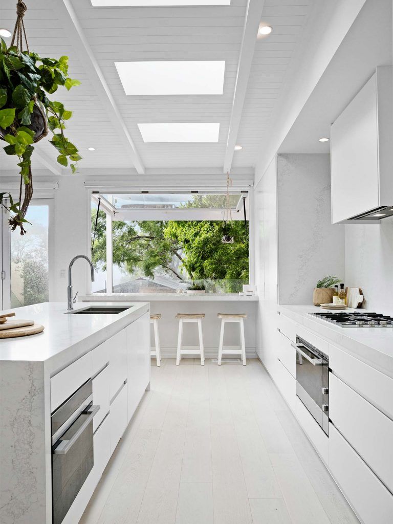 This gas kitchen cooktop blends in seamlessly with the rest of the kitchen counter and bright, white kitchen. #kitcheninspiration via www.L-2-Design.com
