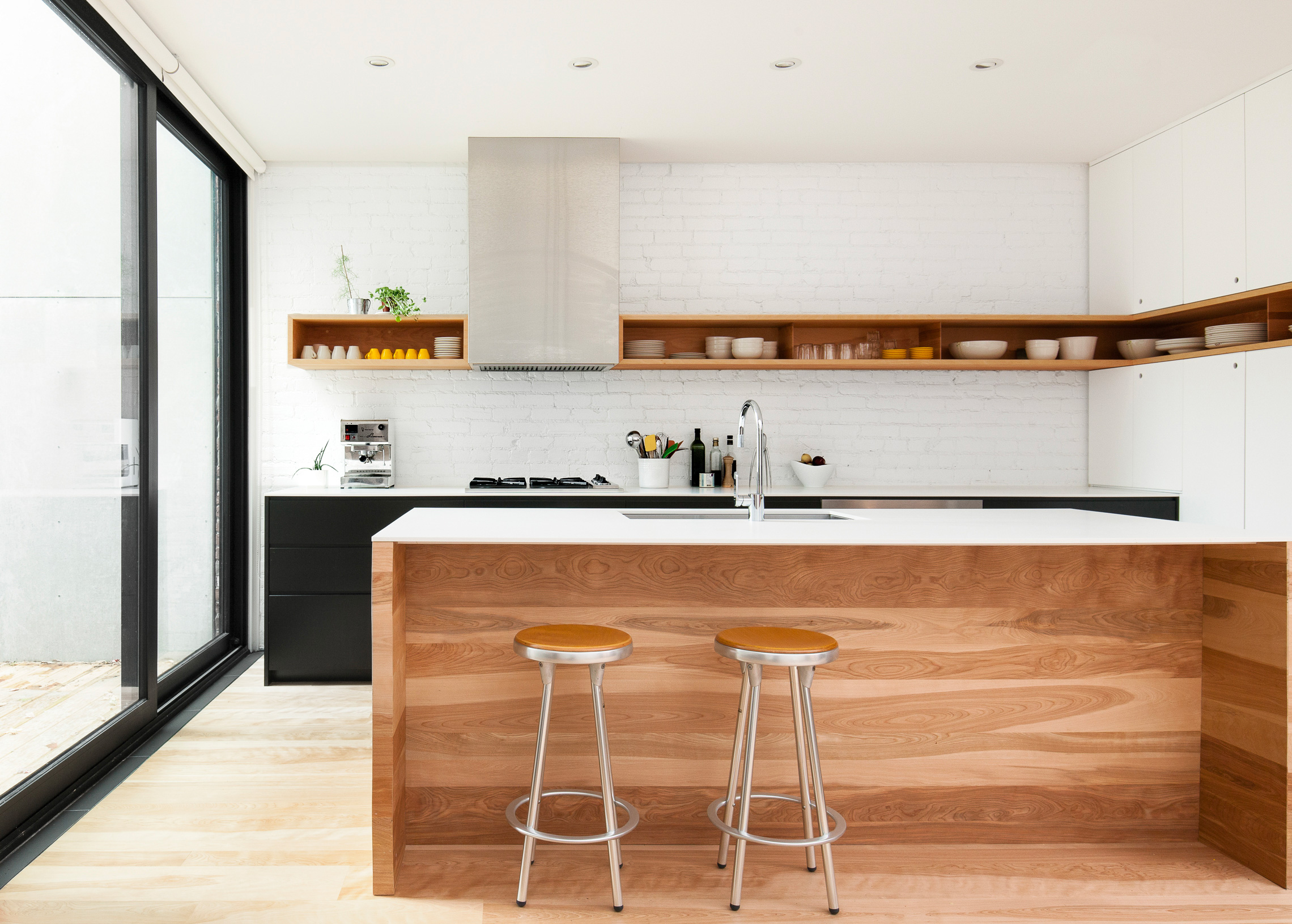 This boxed, stainless steel range hood design by la SHED sits in alignment with an open shelf design that wraps the kitchen.#kitcheninspiration via www.L-2-Design.com